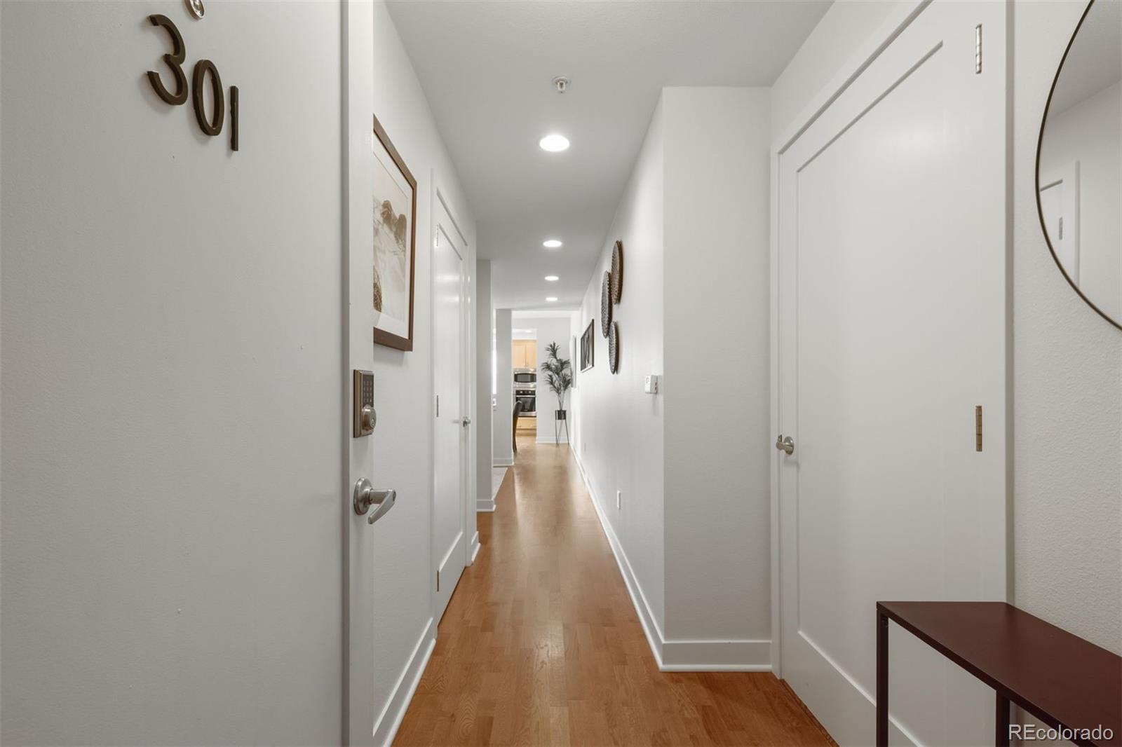 360 South Lafayette Street, Unit 301 Denver, CO 80209 - Photo 23 of 29 a view of a hallway with wooden floor and closet