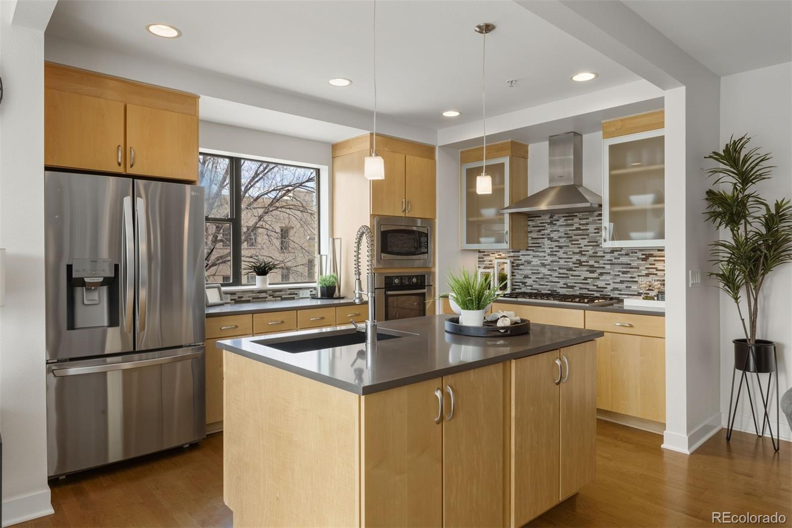 360 South Lafayette Street, Unit 301 Denver, CO 80209 - Photo 7 of 29 a kitchen with stainless steel appliances granite countertop a refrigerator a sink and a stove