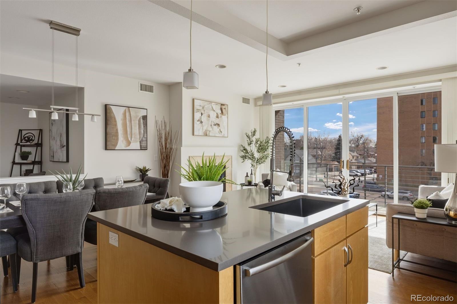 360 South Lafayette Street, Unit 301 Denver, CO 80209 - Photo 8 of 29 a kitchen with a table chairs and wooden floor