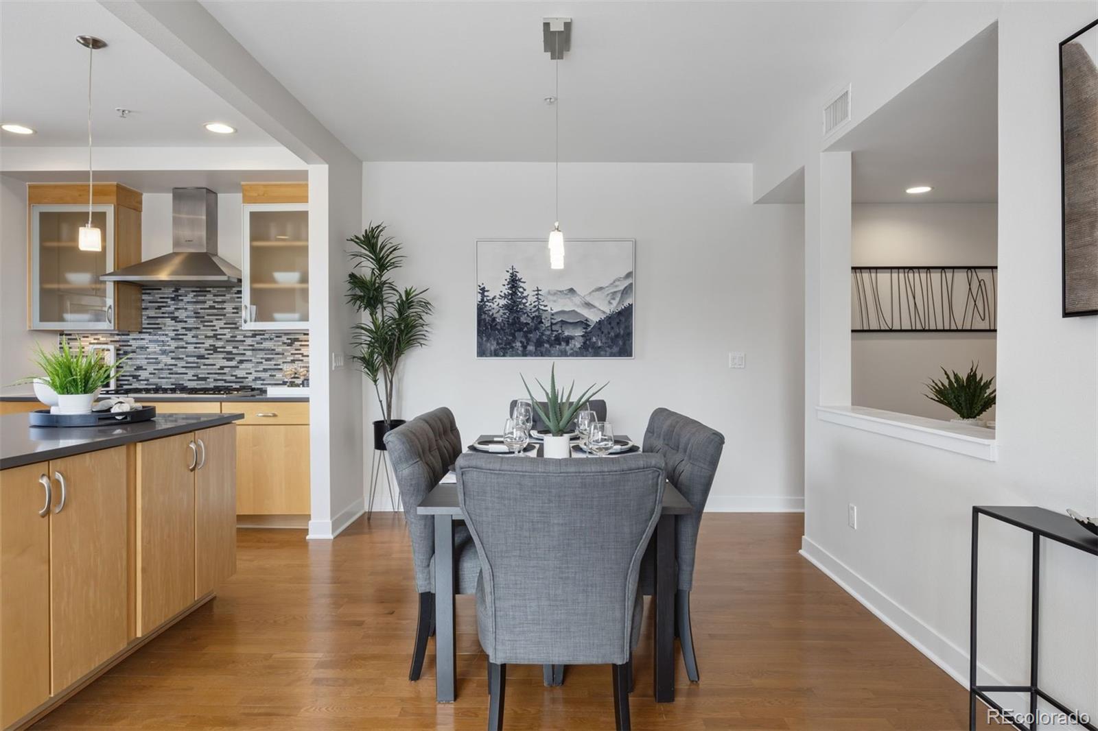 360 South Lafayette Street, Unit 301 Denver, CO 80209 - Photo 9 of 29 a dining room with furniture potted plants and wooden floor
