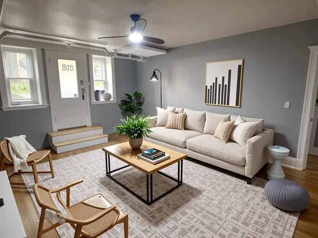 a living room with furniture and a potted plant