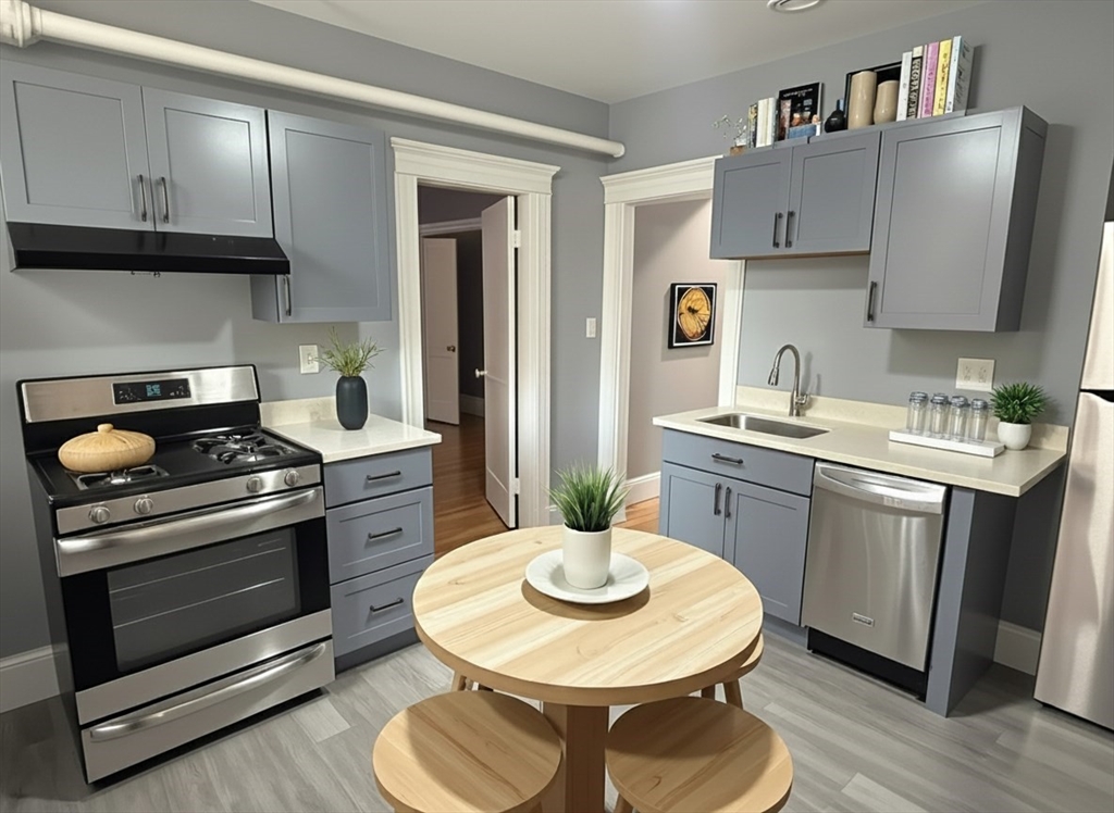 36 St Paul Street, Unit B Brookline, MA 02446 - Photo 2 of 6 a kitchen with stainless steel appliances a stove a sink a chimney a dining table and chairs