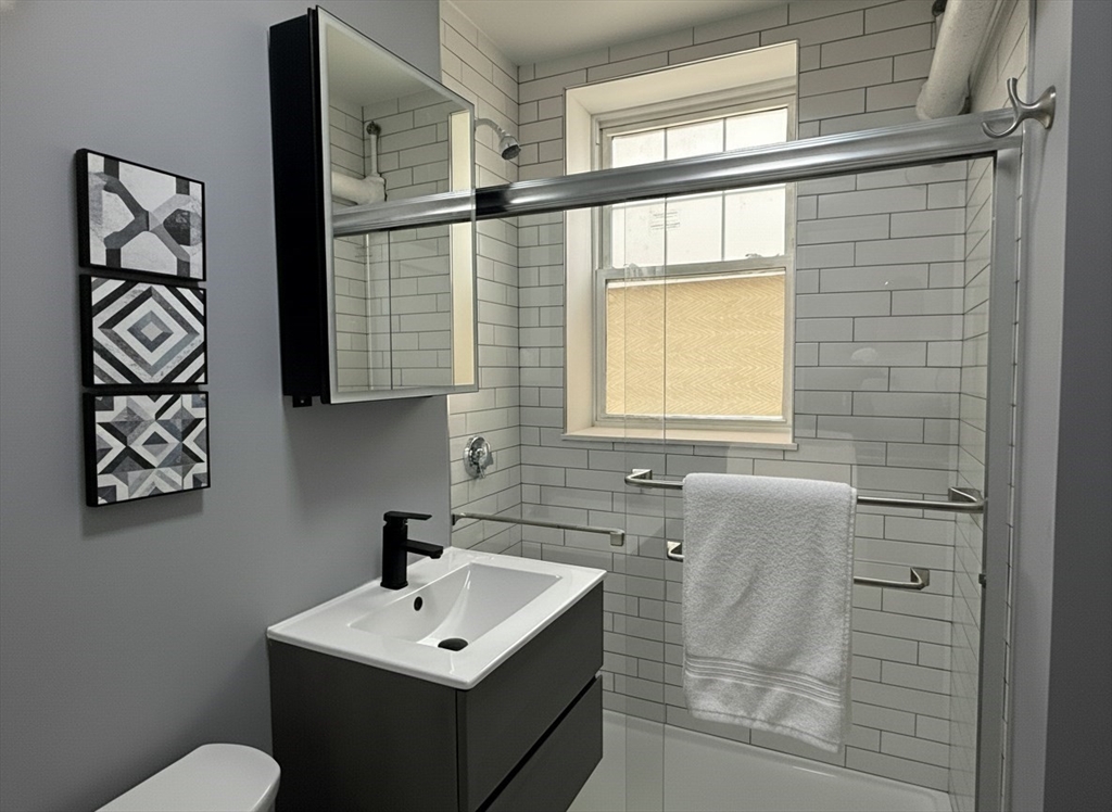 36 St Paul Street, Unit B Brookline, MA 02446 - Photo 4 of 6 a bathroom with a sink and a mirror