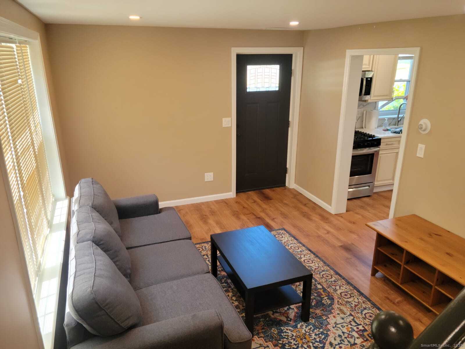 62 High Ridge Drive Bridgeport, CT 06606 - Photo 3 of 14 a living room with furniture and a window