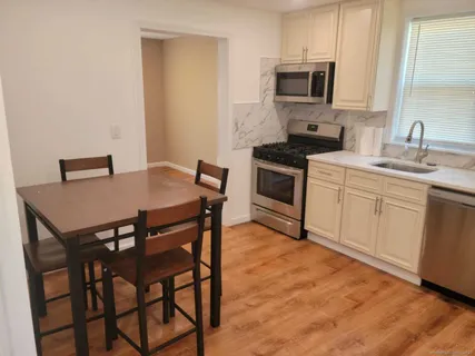 a kitchen that has a table and chairs in it