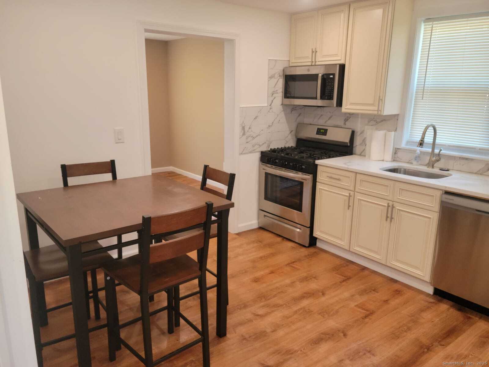 62 High Ridge Drive Bridgeport, CT 06606 - Photo 5 of 14 a kitchen that has a table and chairs in it