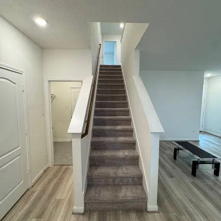 a view of entryway and hall with wooden floor