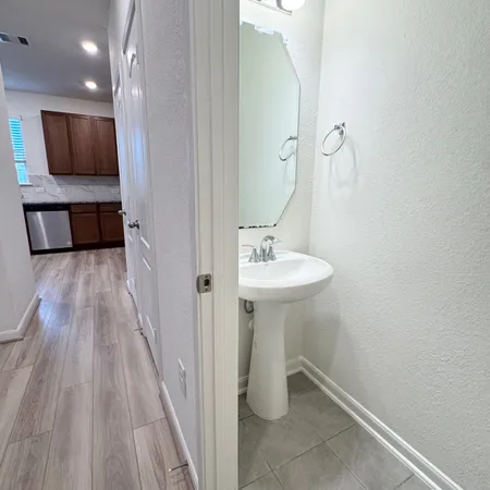 a bathroom with a sink a mirror and shower