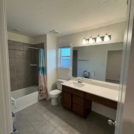 a bathroom with a bathtub a sink and a mirror