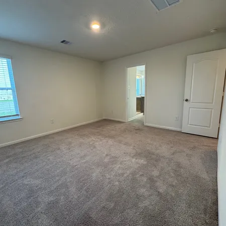 an empty room with closet and mirror