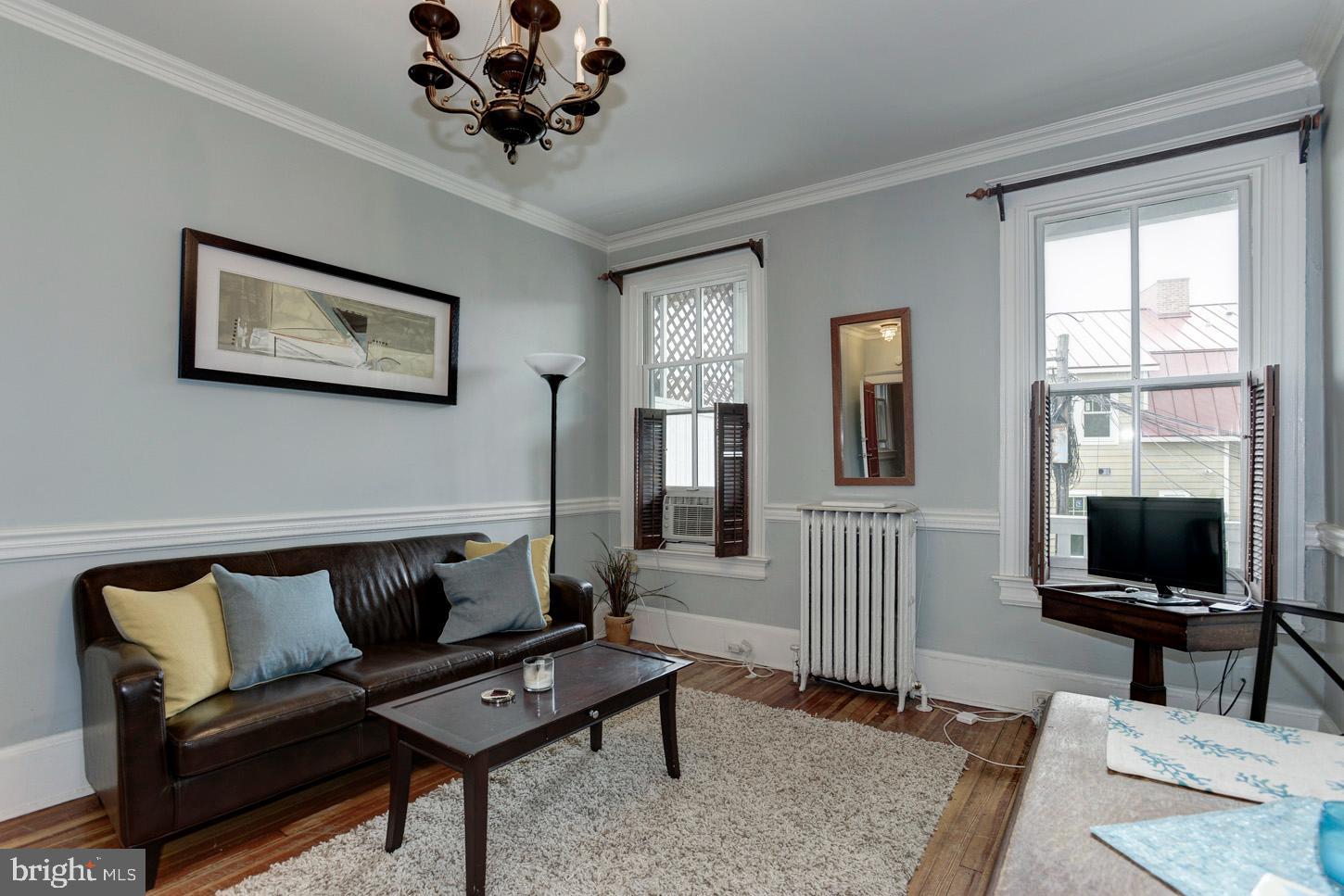 408 6th Street Southeast, Unit 3 Washington, DC 20003 - Photo 3 of 13 a living room with furniture a flat screen tv and a window