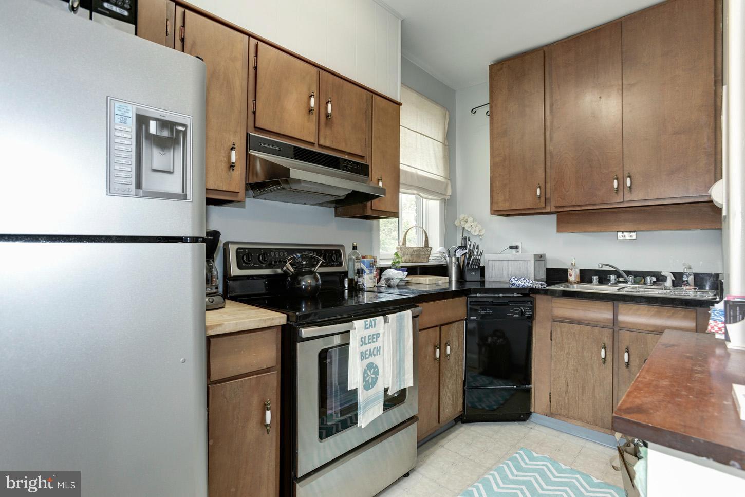 408 6th Street Southeast, Unit 3 Washington, DC 20003 - Photo 6 of 13 a kitchen with stainless steel appliances granite countertop a stove a sink and a refrigerator