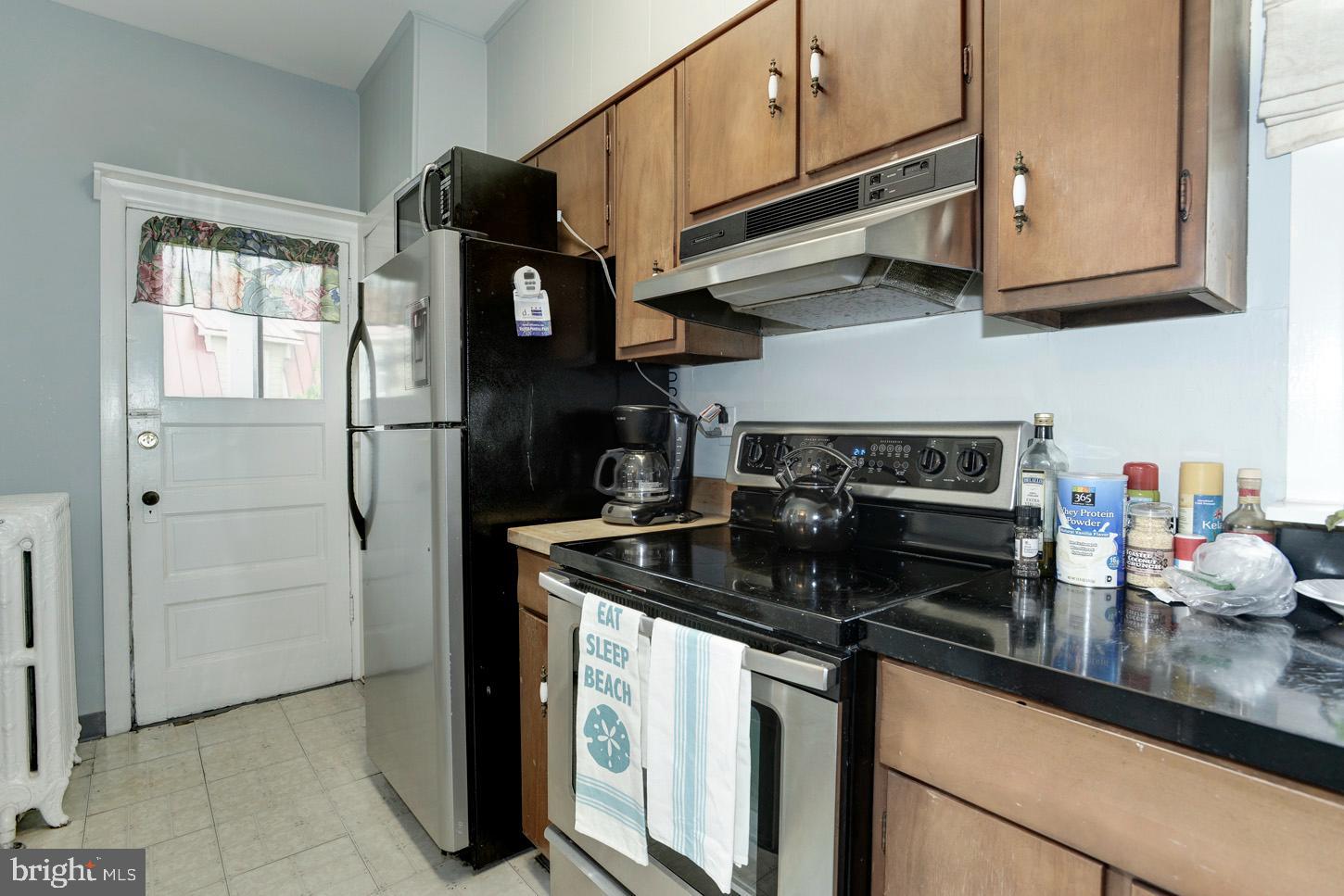 408 6th Street Southeast, Unit 3 Washington, DC 20003 - Photo 7 of 13 a kitchen with stainless steel appliances granite countertop a stove a refrigerator and a cabinets