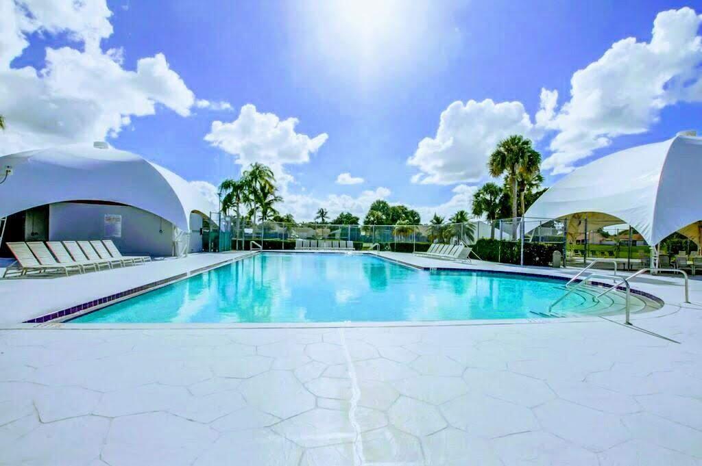 9709 Sunny Isle Circle Boca Raton, FL 33428 - Photo 18 of 21 a view of a lake with a swimming pool