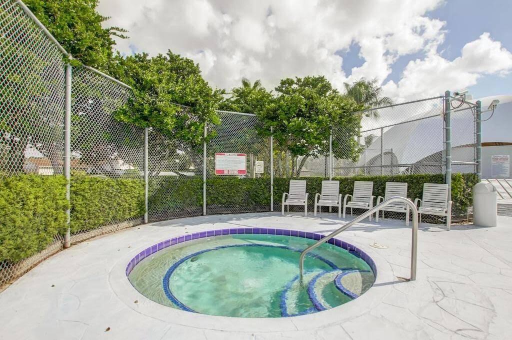 9709 Sunny Isle Circle Boca Raton, FL 33428 - Photo 20 of 21 a view of a swimming pool with a patio