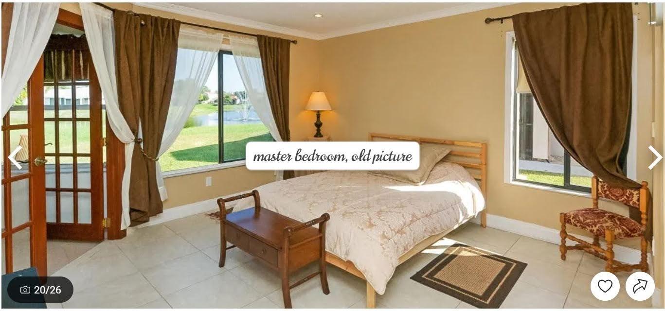 9709 Sunny Isle Circle Boca Raton, FL 33428 - Photo 8 of 21 a bed sitting in a bedroom next to a window