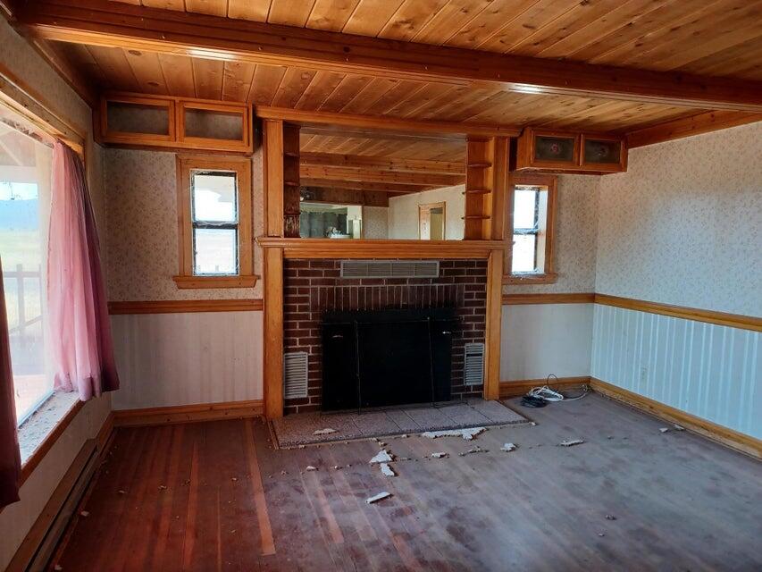 557-435 Center School House Road Bieber, CA 96009 - Photo 19 of 24 a view of empty room with wooden floor and fireplace
