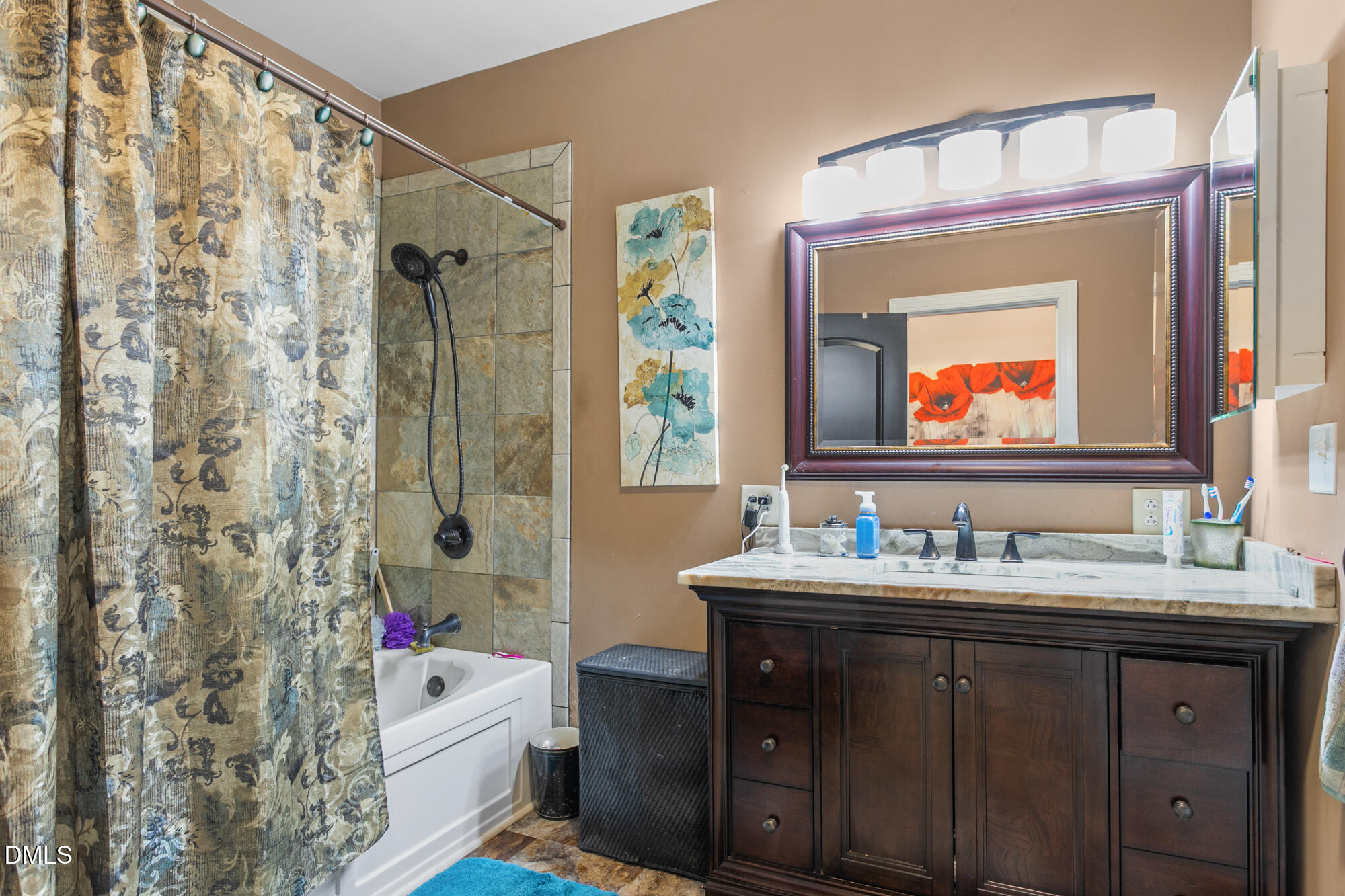 3163 Saul Loop Road Elon, NC 27244 - Photo 18 of 44 a bathroom with a tub sink toilet and a mirror