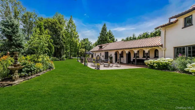 a front view of a house with garden and porch