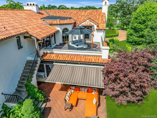 aerial view of a house with swimming pool and next to a yard