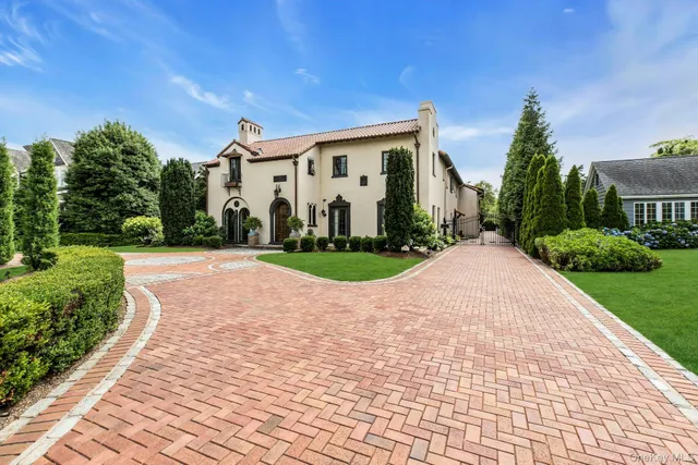 a view of a white house with a yard