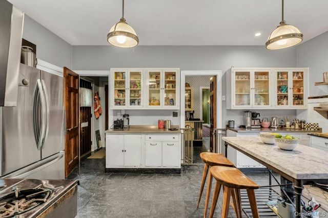 a kitchen with a refrigerator a stove and a sink