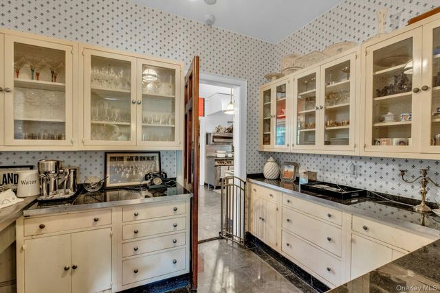 a kitchen with granite countertop a sink and cabinets