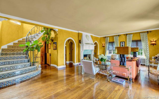 a living room with furniture pool view and large windows
