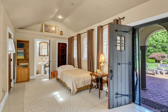 a spacious bedroom with a bed and a large mirror