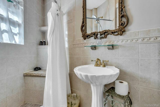 a bathroom with a sink toilet and mirror