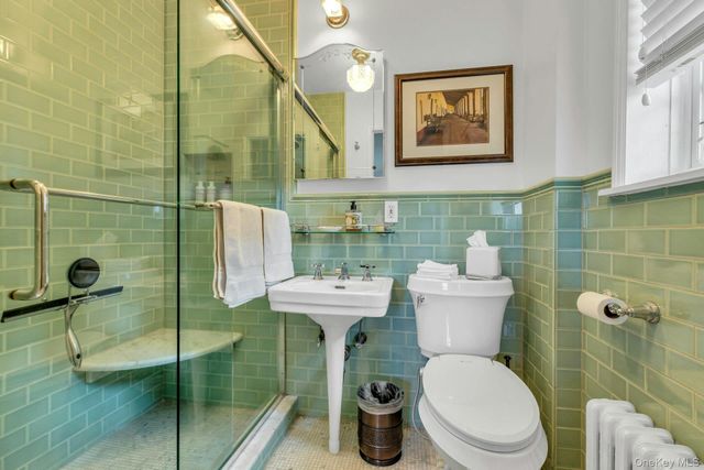 a bathroom with a toilet sink and shower
