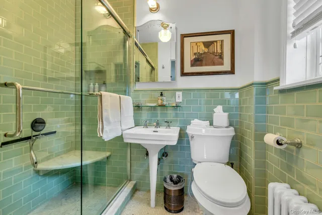 a bathroom with a toilet sink and shower