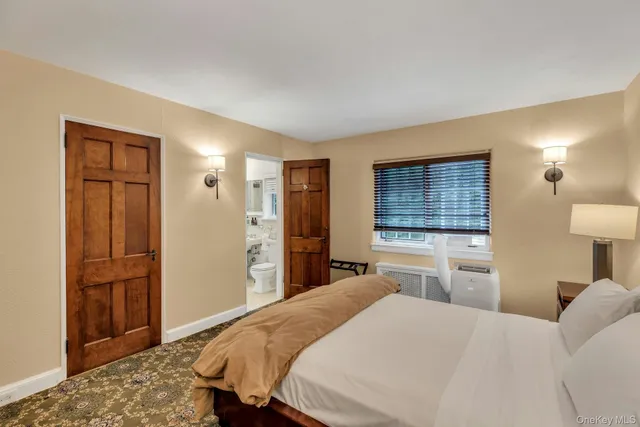 a bedroom with a bed and a dresser in it