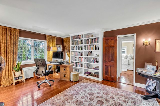 a view of a livingroom with workspace and a window