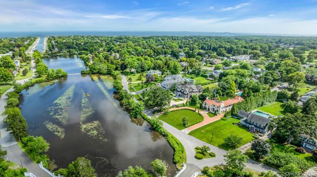 an aerial view of a house with a yard lake swimming pool and outdoor seating