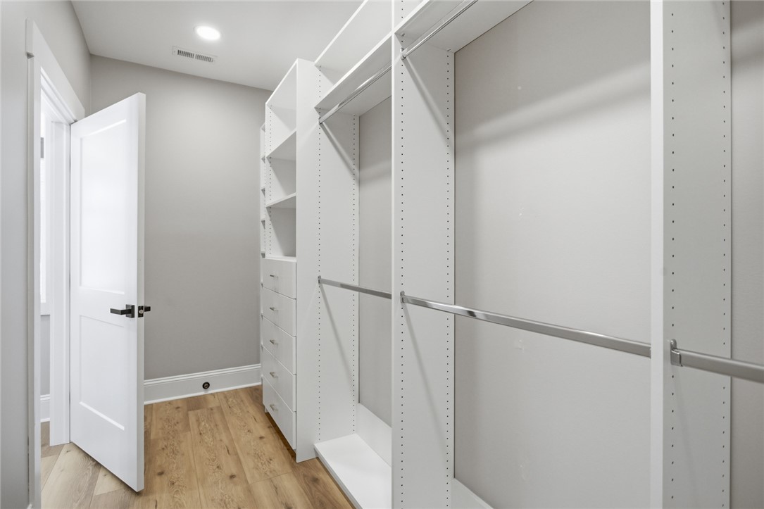 147 McAlister Road West Union, SC 29696 - Photo 18 of 49 This spacious closet features custom shelving, ample storage, and warm flooring.