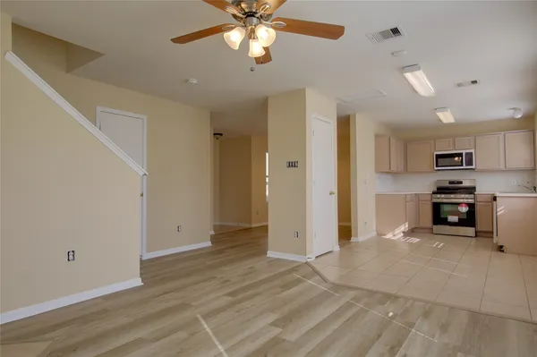 a view of a kitchen with a sink cabinets and stainless steel appliances