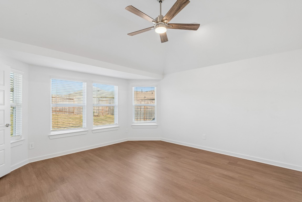 707 Hackberry Branch Magnolia, TX 77354 - Photo 12 of 50 an empty room with wooden floor fan and windows