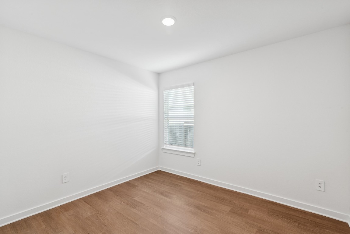 707 Hackberry Branch Magnolia, TX 77354 - Photo 13 of 50 an empty room with wooden floor and windows