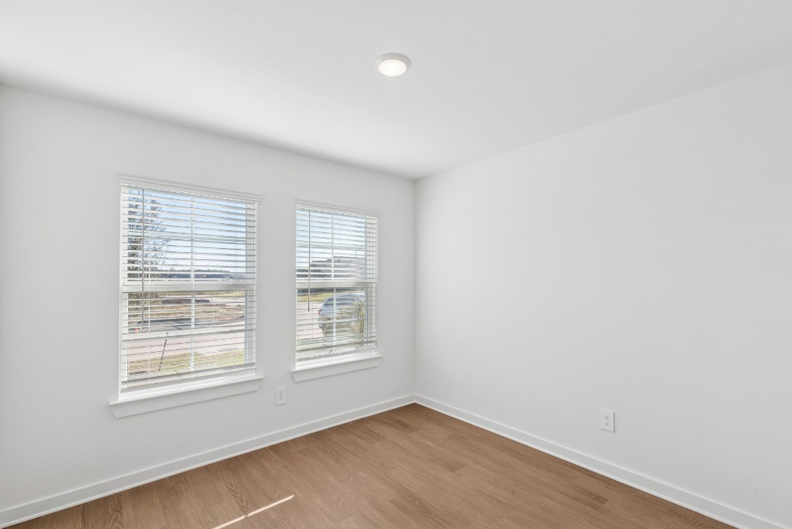 707 Hackberry Branch Magnolia, TX 77354 - Photo 14 of 50 an empty room with wooden floor and windows