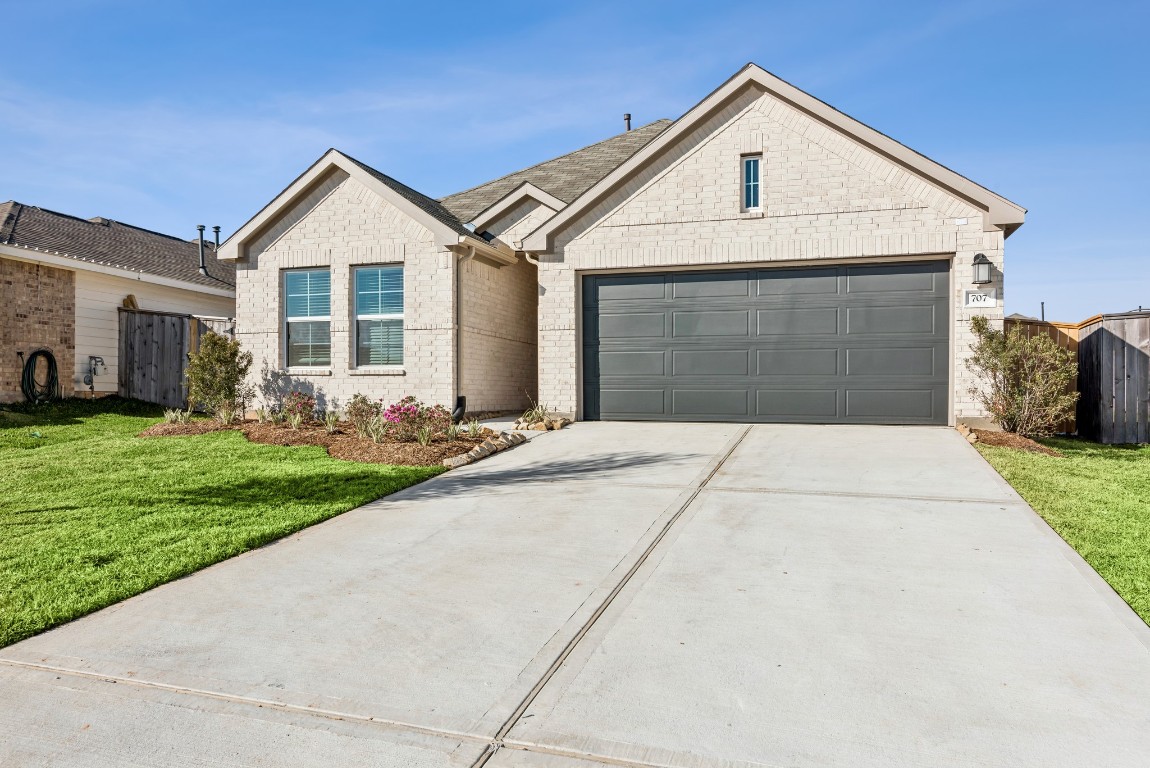 707 Hackberry Branch Magnolia, TX 77354 - Photo 17 of 50 a front view of a house with garden