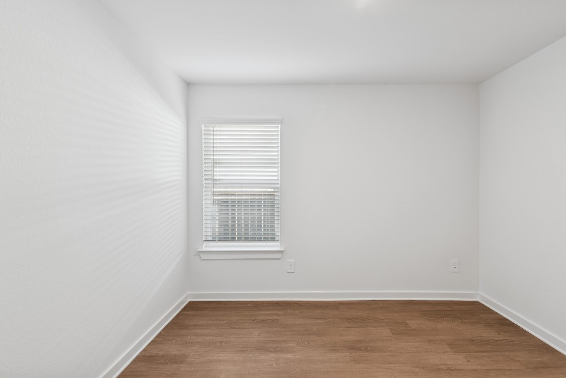 707 Hackberry Branch Magnolia, TX 77354 - Photo 25 of 50 a view of an empty room with wooden floor and a window