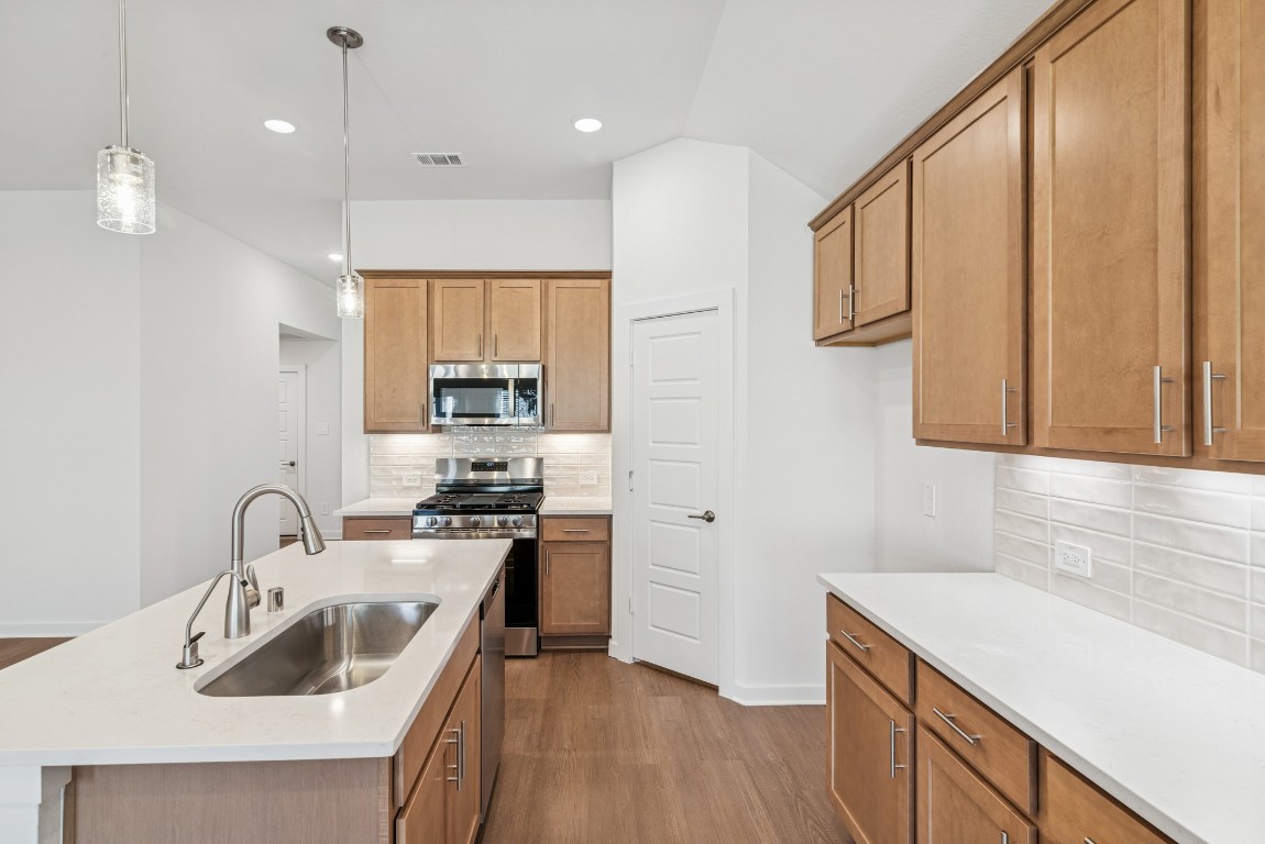 707 Hackberry Branch Magnolia, TX 77354 - Photo 29 of 50 a kitchen with a sink stove and cabinets