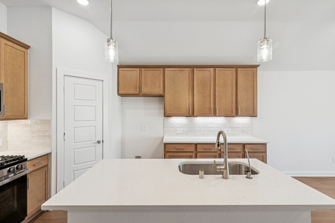707 Hackberry Branch Magnolia, TX 77354 - Photo 30 of 50 a kitchen with a sink a stove and a refrigerator
