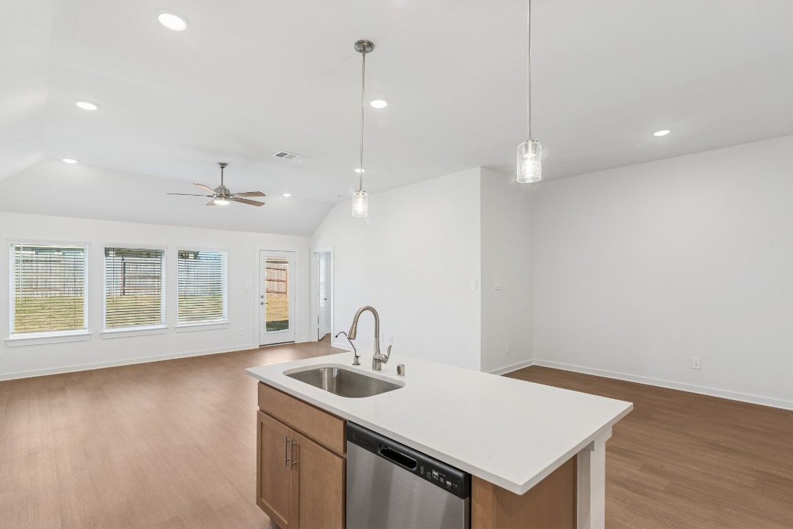 707 Hackberry Branch Magnolia, TX 77354 - Photo 32 of 50 a kitchen with a sink chandelier and wooden floor