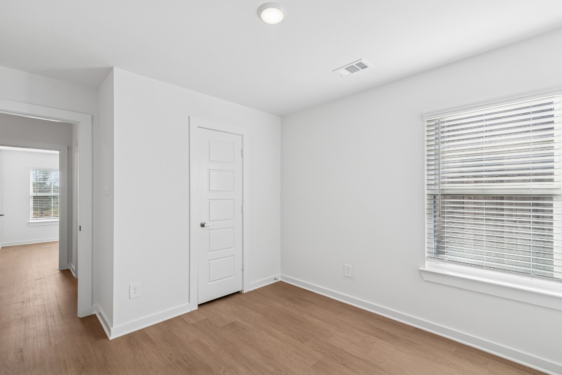 707 Hackberry Branch Magnolia, TX 77354 - Photo 41 of 50 a view of an empty room with wooden floor and a window