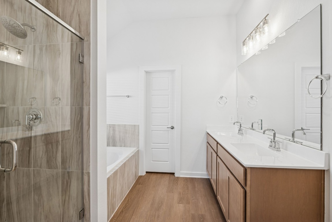 707 Hackberry Branch Magnolia, TX 77354 - Photo 5 of 50 a bathroom with a sink a mirror and a shower