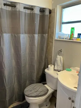a bathroom with a sink toilet and a shower