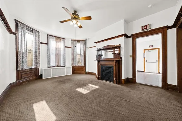 a living room with furniture a fireplace and a large window