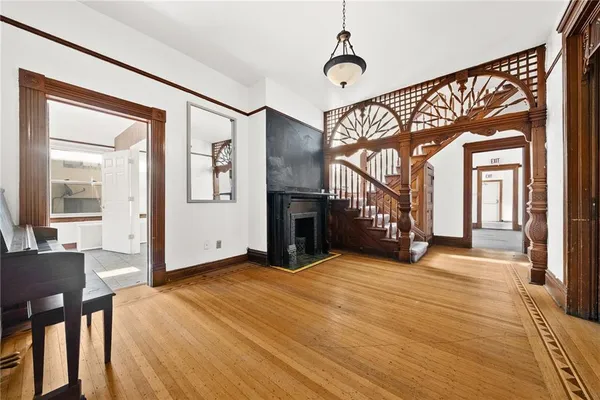 a view of entryway and hall with wooden floor